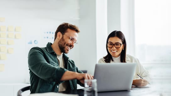 2 people looking at laptop 