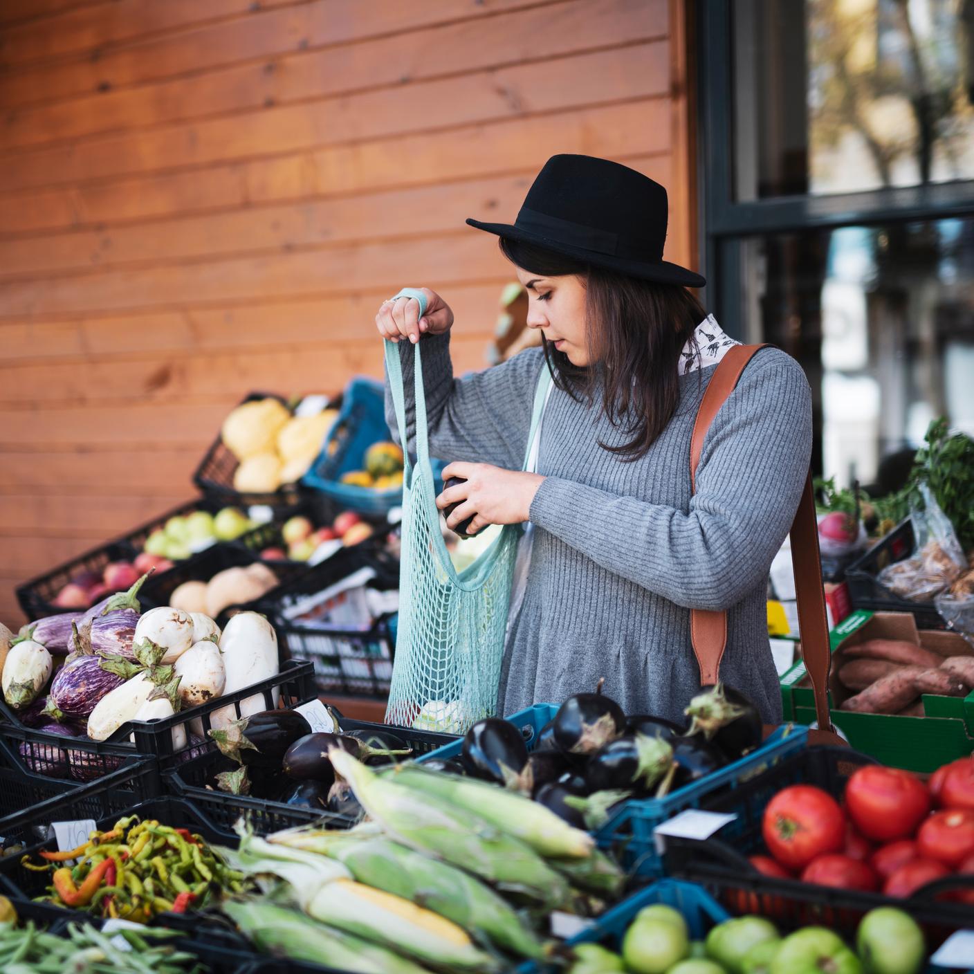 women buying produce from market