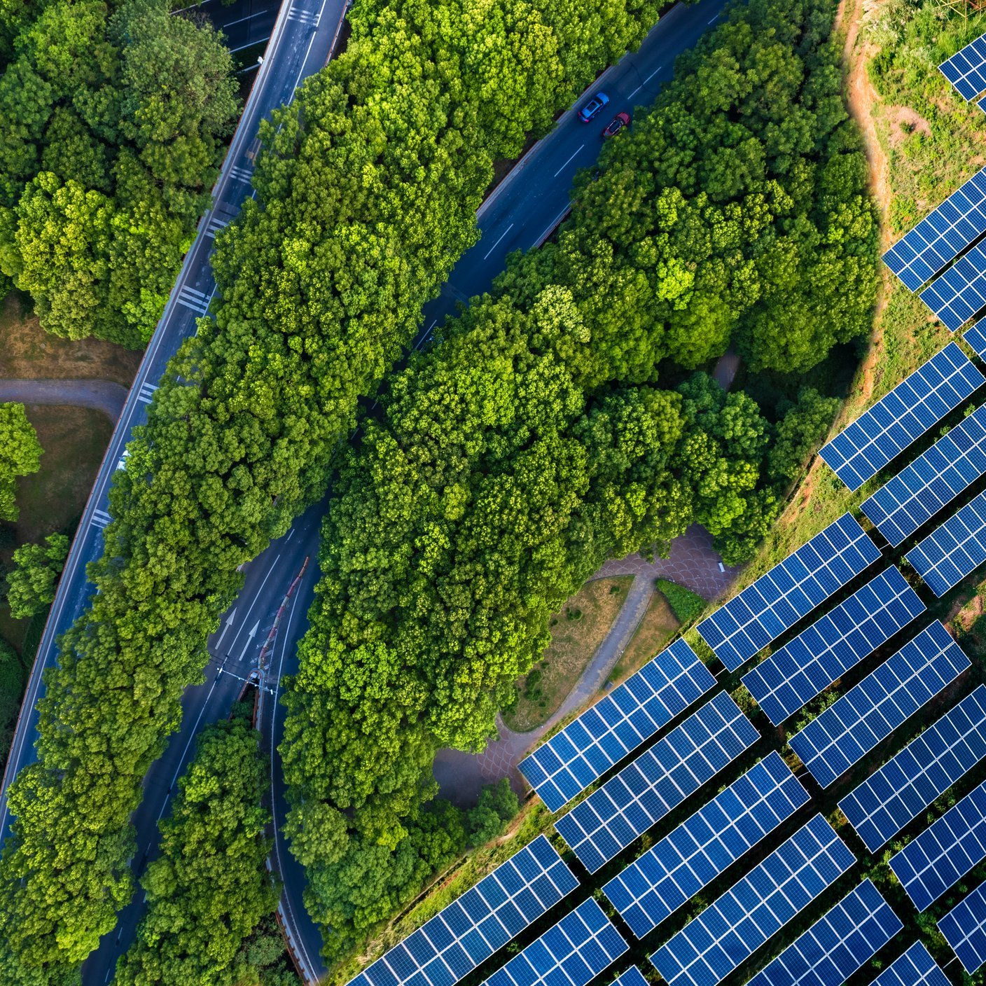 High angle view of Solar panels , agricultural landscape. Winding coastal road on turquoise coloured lake. Pudong, shanghai, China