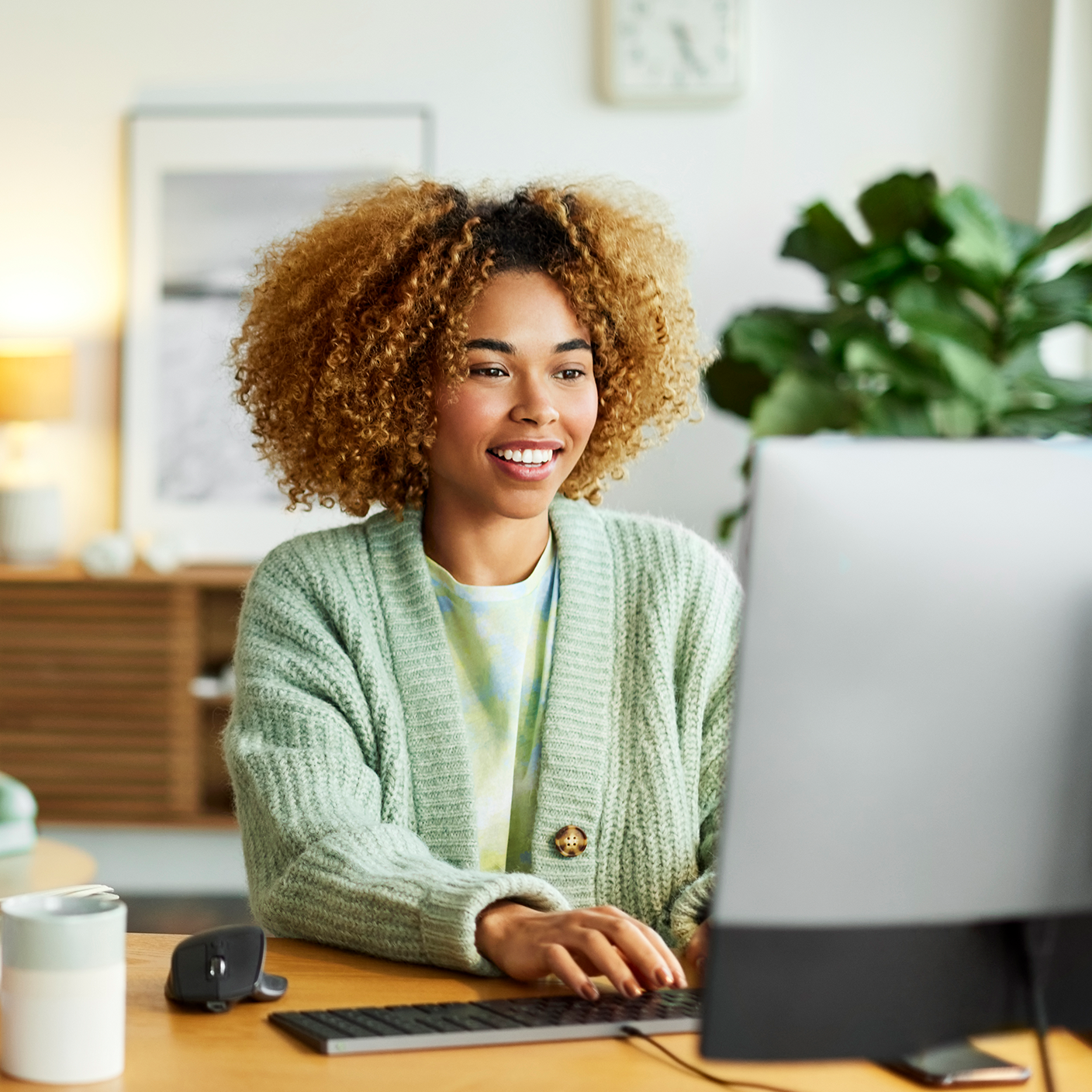 Female freelancer using computer while colleague in background.
