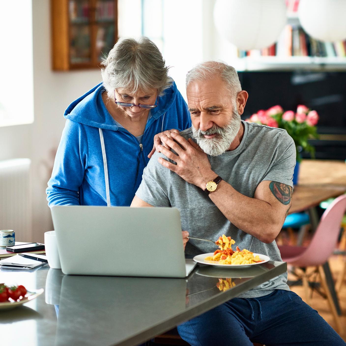 old couple working at laptop