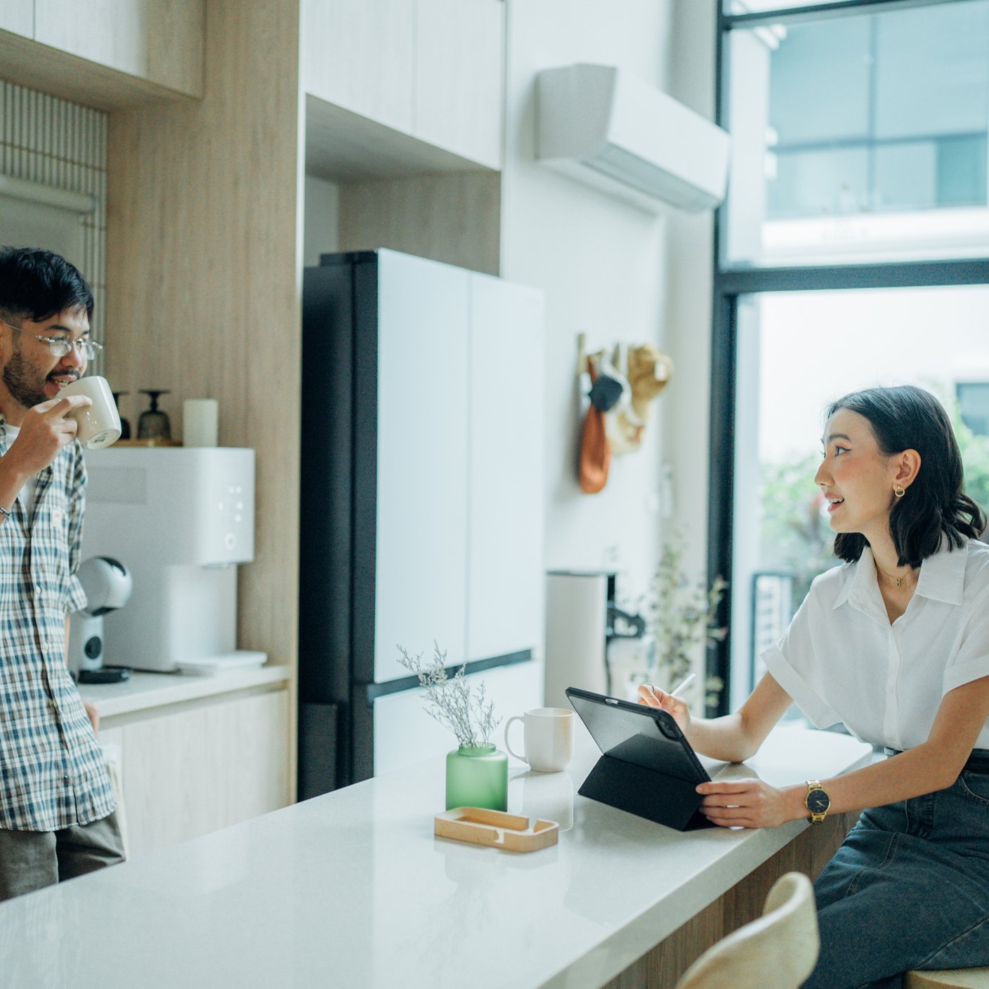 Young woman and a man drinking tea together in an apartment