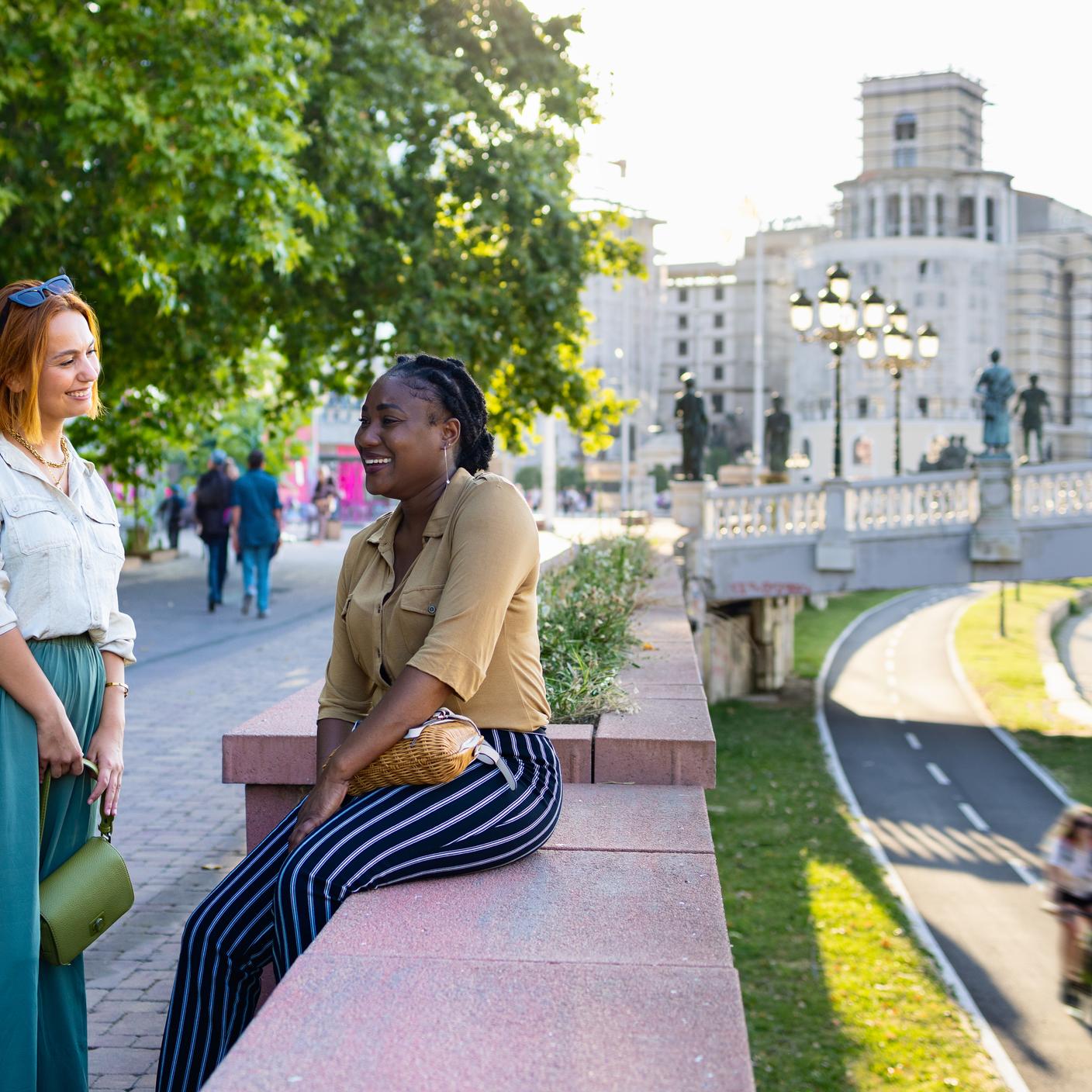 Two females socializing in public area 