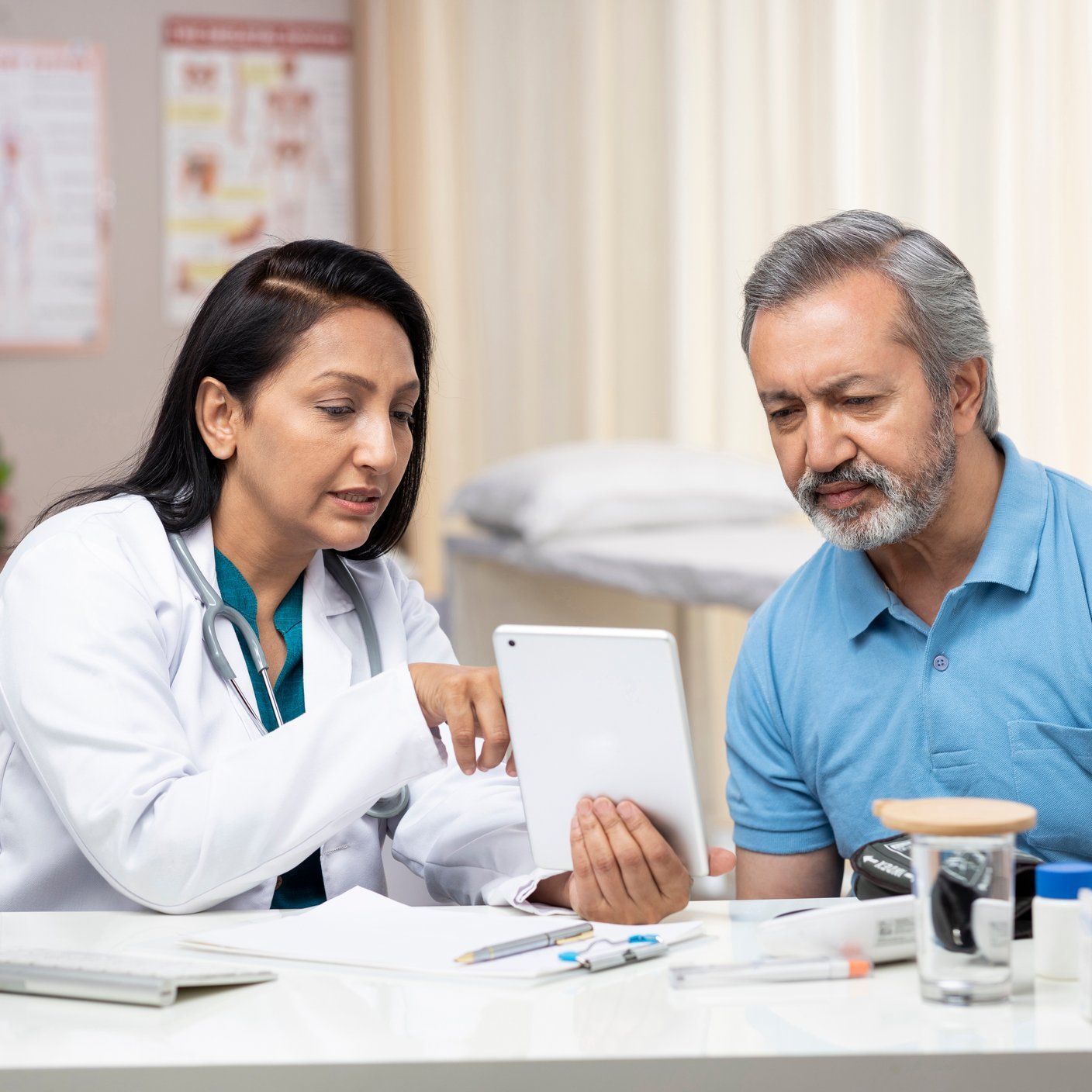 Doctor showing patient results on tablet 