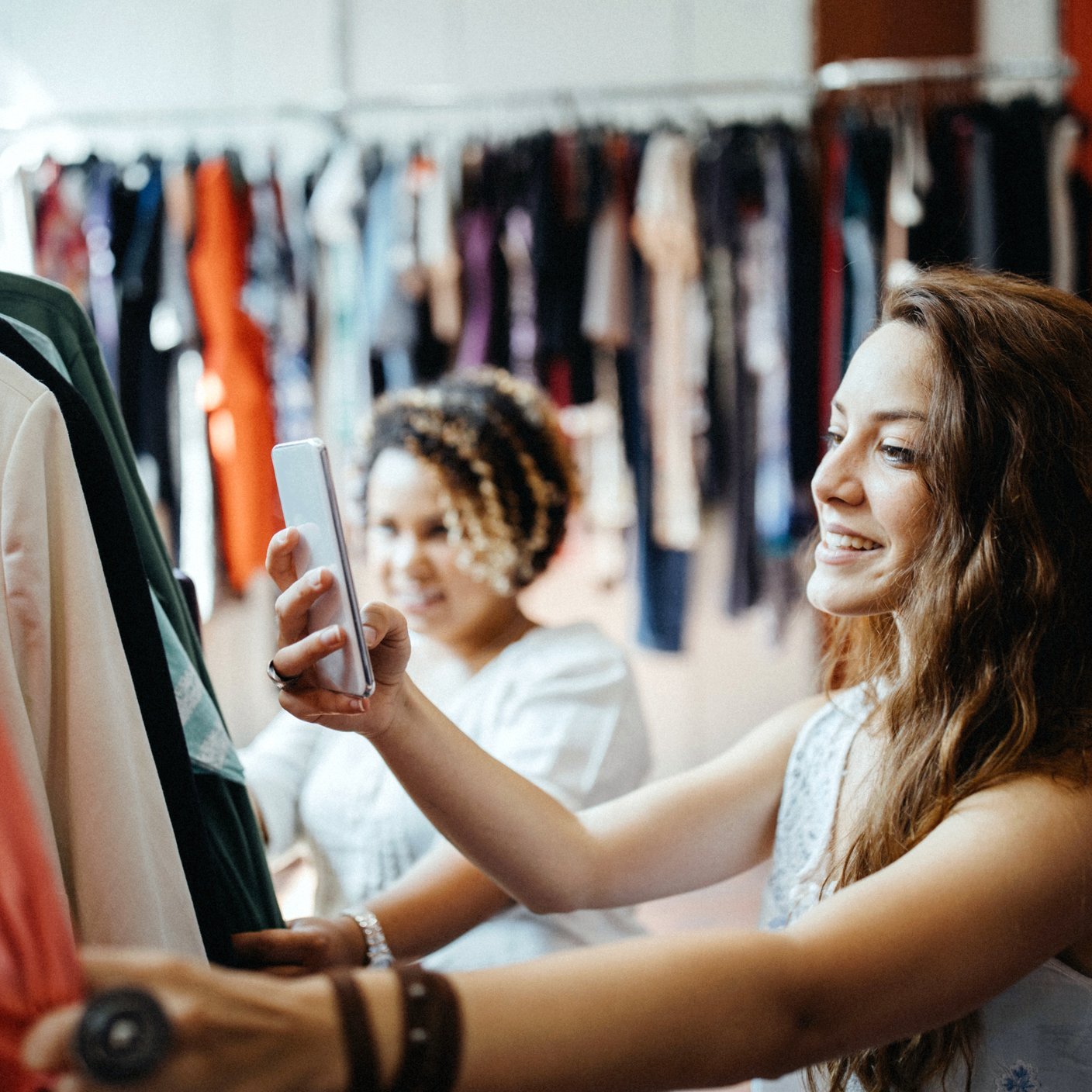 Young women vintage clothes shopping