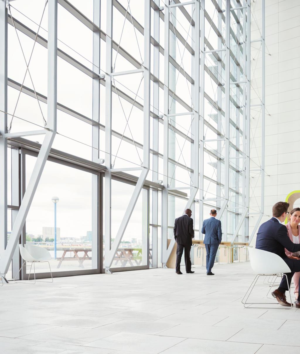 Business people discussing plans in modern lobby