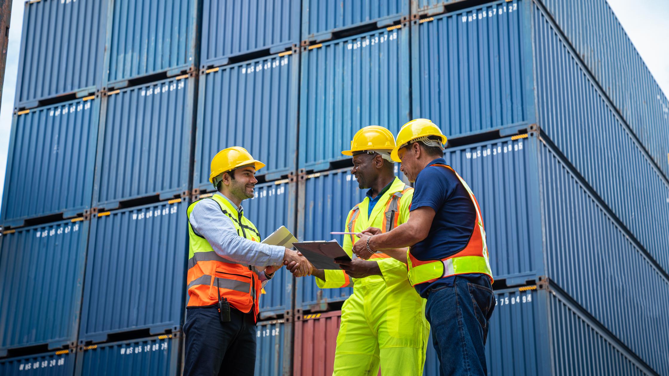 Industrial Engineer and Foreman control checking container at container yard warehouse. 
